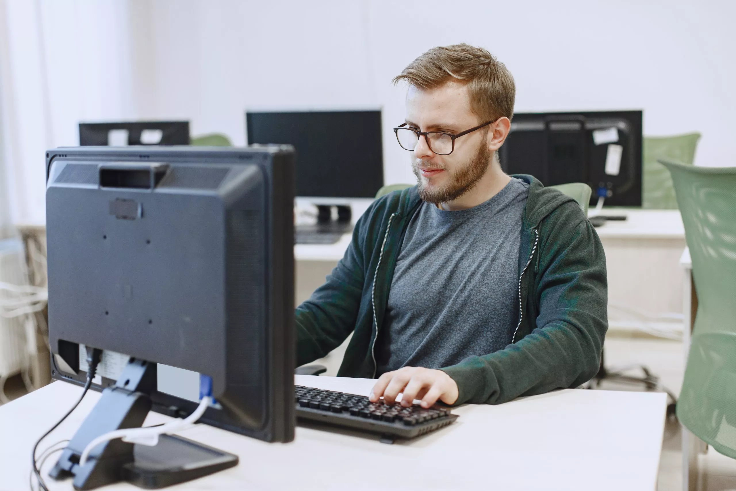 Ein Mitarbeiter der TrioptGroup arbeitet an seinem Computer
